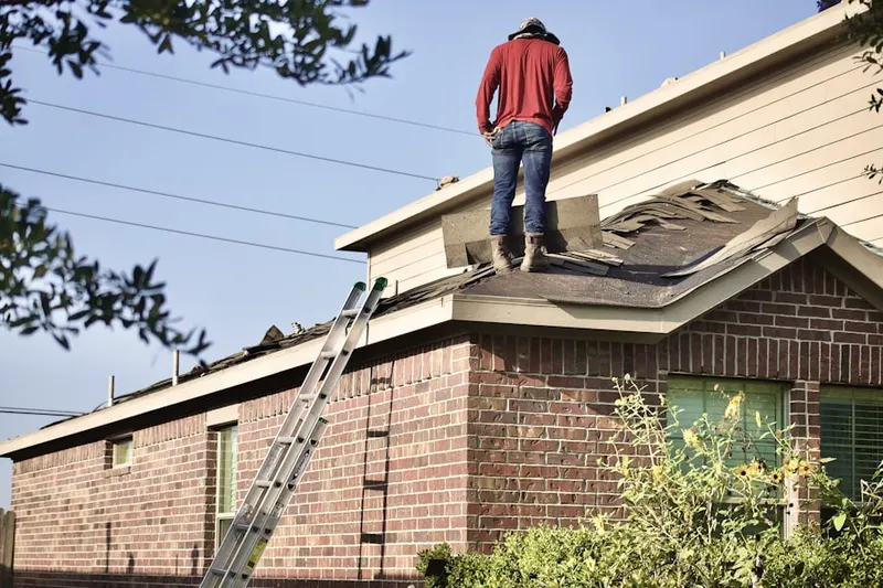 Professional roofer working on a residential roof in Keymar